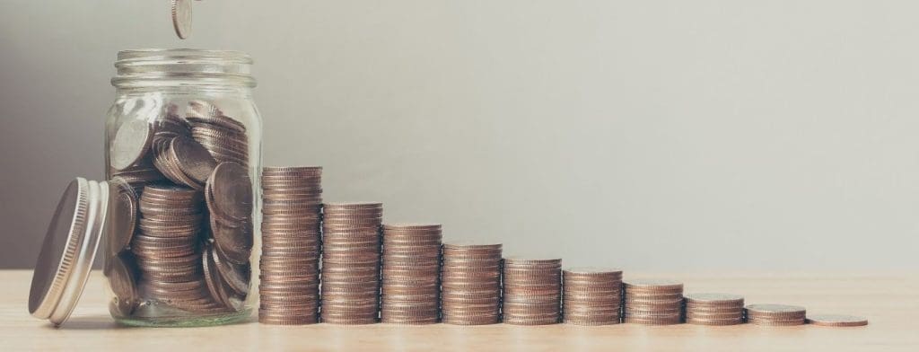 coins in a jar and stacks next to it