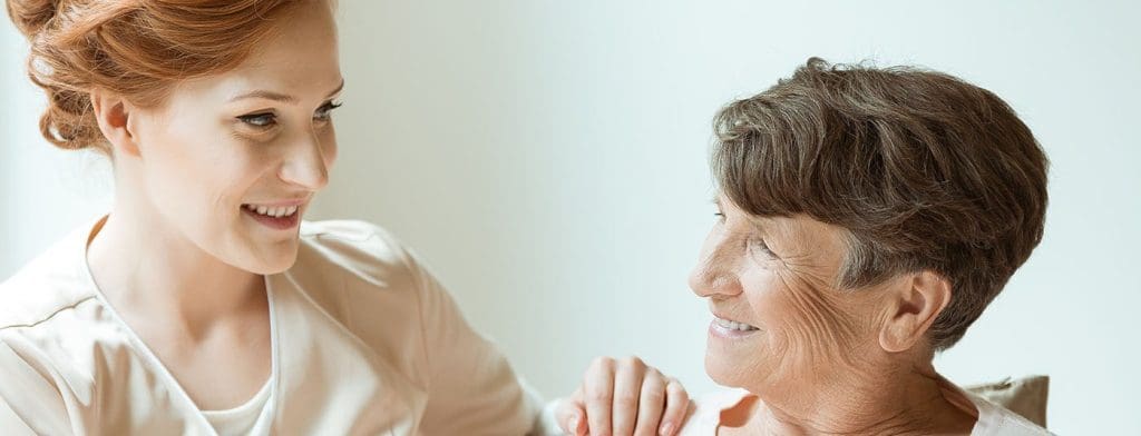 Nurse helping elderly woman