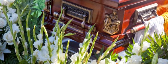 white flowers surrounding funeral casket