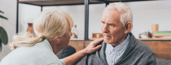 elderly woman looking at elderly man