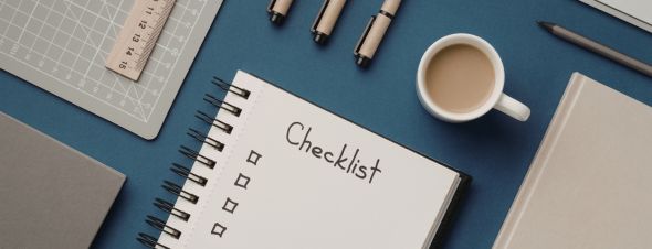 checklist with pens and coffee cup