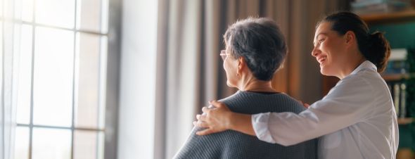 elderly woman with nursing home worker