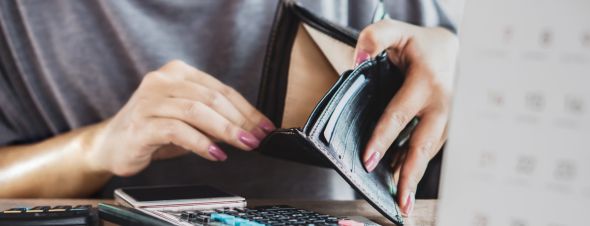 woman looking in empty wallet