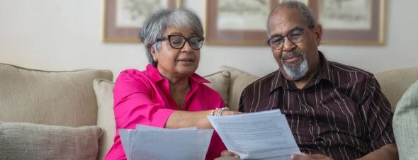 elderly couple discussing documents